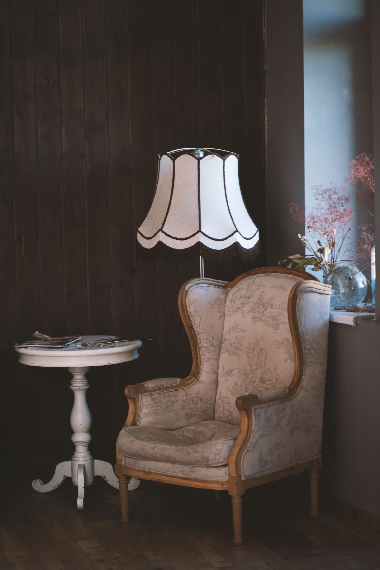 Reading corner with an armchair, side table, and floor lamp